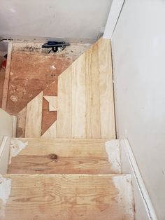 the stairs are being built and ready to go up in the house with wood flooring