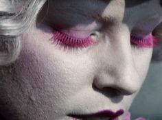 a woman with white hair and pink makeup