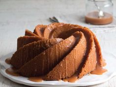 a bundt cake on a plate with caramel sauce drizzled over it