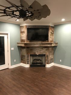 an empty living room with a fireplace and flat screen tv