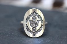 "This listing is for one sterling silver celestial butterfly and fern ring featuring unique and rich details. A beautiful monarch butterfly sits inside of detailed leaves and branches with a crescent moon with a star on each side. Th artwork is forged into the silver sheet and patinated and curved around a sturdy 10 gauge sterling silver half round band. Marked 925 for sterling silver. This ring is perfect for any nature and butterfly lover!. -Choose your size at checkout! - Butterfly focal meas Fern Ring, Celestial Butterfly, Silver Butterfly Ring, Gem Rings, Moon Butterfly, Ring Butterfly, Ring Moon, Celestial Ring, Shield Ring