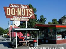 a donut shop with a sign that says do - nuts on the front and side