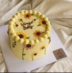 a yellow cake with sunflowers on it