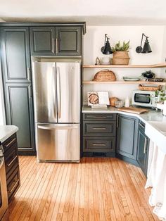 a metallic refrigerator freezer sitting inside of a kitchen