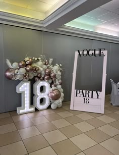 an arrangement of balloons and decorations in the shape of numbers are on display at a party