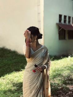 a woman in a sari talking on her cell phone