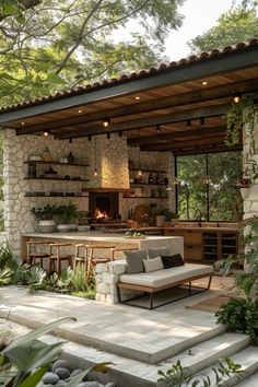 an outdoor kitchen and living area with stone walls