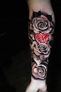 a woman's arm with roses and a heart on it