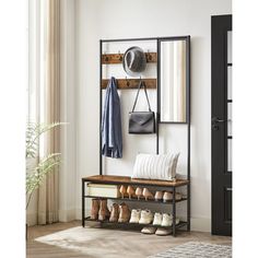 a coat rack with shoes and hats hanging on the wall next to a door in a room