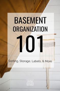 the words basement organization 101 sitting on top of a white wall with fringes hanging from it