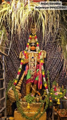 the statue of lord ganesh is surrounded by plants