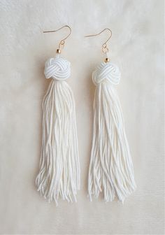 These are Beautiful, Light weight Knotted Tassel Earrings in Woven knotted Tassel Accents Color options:  1. Burgundy 2. Dark Green 3. Black 4. Yellow 5. White 6. Royal Blue 7. Red Length: 5 inches approx. Width: 0.5 inches It has a Gold tone Brass Metal Hook with a plastic backing for closure Super light weight and so comfortable to wear for any occasion. A Perfect gift for a loved one. Care instruction: 1. Avoid contact with water as the jewelry pieces are not waterproof. 2. Clean all pieces with a soft dry cloth to remove any substances or chemicals such as hair spray or perfume. Bohemian Handmade Tassel Earrings For Wedding, Handmade White Bohemian Tassel Earrings, Bohemian White Tassel Earrings For Pierced Ears, Bohemian White Jewelry With Latkans, White Bohemian Jewelry With Latkans, Elegant White Tassel Earrings, Bohemian White Tassel Earrings For Party, Handmade Dangle Tassel Earrings For Wedding, Elegant White Tassel Earrings For Pierced Ears