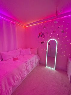 a bedroom with pink lights and a large bed in the corner, along with a mirror on the wall