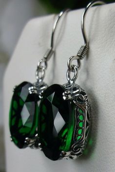 Simulated Green Emerald Earrings Edward Design#E70 Custom Made This is a brand new beautiful Victorian/Edwardian-inspired filigree sterling silver pair of simulated green emerald earrings. The lovely full cut oval stones are 14mm (5/8th of an inch) by 10mm (1/2 inch) in size each. The earrings are marked 925. The earrings are 1 and 1/4th inches long. Notice the beautiful swirl/heart like the craftsmanship of the silver filigree settings. This is a well made beautiful pair of sterling earrings an Classic Green Drop Earrings, Elegant Green Metal Teardrop Earrings, Green Oval Jewelry For Party, Green Metal Teardrop Earrings Elegant Style, Elegant Green Teardrop Metal Earrings, Green Metal Earrings For Formal Occasions, Oval Pierced Jewelry For Party, Green Teardrop Pierced Earrings As A Gift, Green Teardrop Pierced Earrings For Gift