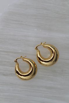 18k Gold Plated 12mmx25mm Brass Make a statement with our Chunky Gold U-Hoops—the perfect blend of boldness and elegance. These U-shaped earrings are crafted from high-quality, gold-plated material, offering a luxe, polished finish that complements any outfit. Designed for those who love a touch of vintage flair with modern appeal, these earrings are both versatile and timeless. Ideal for elevating your everyday style or adding a glamorous touch to your evening look, these Chunky Gold U-Hoops ar Chic Gold Earrings For Work, Chic Gold Earrings For Workwear, Luxury Gold Plated Huggie Earrings With Polished Finish, Luxury Gold-plated Huggie Earrings With Polished Finish, Classic Yellow Gold Earrings For Work, Luxury Gold Shiny Huggie Earrings, Luxury Gold Huggie Earrings With Shiny Finish, Modern Chunky Yellow Gold Jewelry, Chic Everyday Jewelry With Gold-tone Hardware