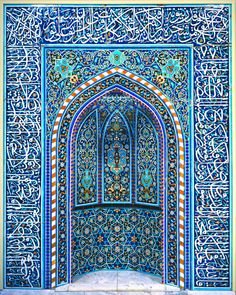 the entrance to an ornate building with arabic writing on it and blue tiles inlays