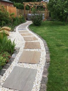 a stone path in the middle of a garden