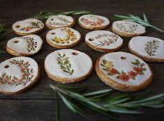 some cookies decorated with flowers and leaves are sitting on a table