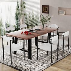 a dining room table with white chairs and an area rug on the floor that is decorated with plants