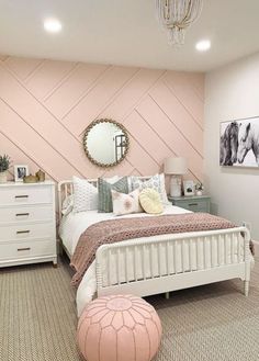 a bedroom decorated in pastel colors with pink accents and white furniture, including a bed