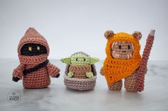 three crocheted amigurt toys sitting next to each other