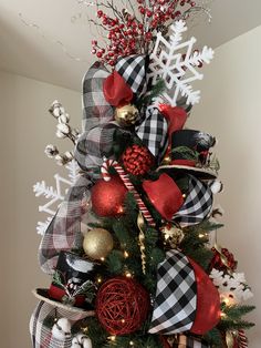 a christmas tree decorated with red, white and black decorations