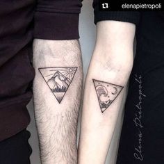 two people with matching tattoos on their arms, one has a mountain and the other has a moon