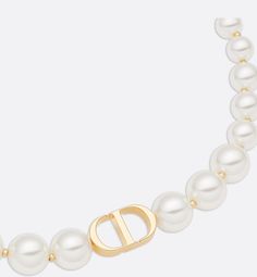 Dior rediscovers its origins and heritage in the 30 Montaigne collection. While keeping its timeless and elegant look, the short necklace is reimagined in a modern design. Delicately adorning the neck, white resin pearls punctuated by minuscule gold-tone beads showcase a CD signature.. Dior Pearl Necklace, Resin Pearl, Dior Necklace, Dior Star, Icon Shoes, Dior Jewelry, Chanel Jewelry, Silver Cufflinks, Fashion Jewelry Earrings