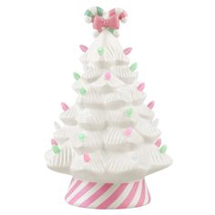 a white ceramic christmas tree with pink and green candy