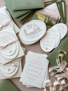 the wedding stationery is laid out on top of each other, including cards and envelopes