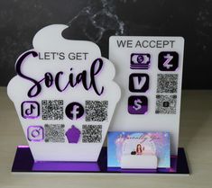 there is a sign that says let's get social with pictures and qr - code on it