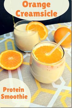 two glasses of orange creamsice sitting on top of a table