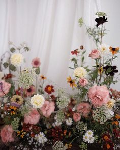 a bunch of flowers that are sitting on a table