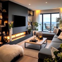 a living room filled with furniture and a flat screen tv mounted to the side of a wall