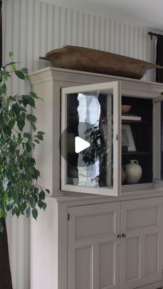 an old china cabinet with a boat on top