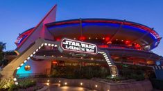 the entrance to star wars launch bay at night