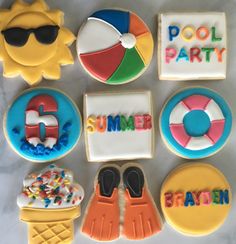 decorated cookies are arranged in the shape of sun, beach ball, and pool party