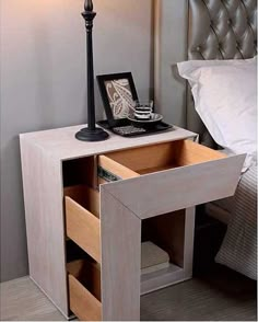 a night stand with two drawers and a lamp