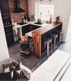 a kitchen with an island and stools next to the stove top oven in it