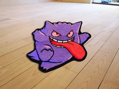 an image of a cartoon character on the floor with tongue sticking out from it's mouth