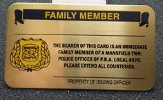 a gold metal sign that says family member on the front and back side of it