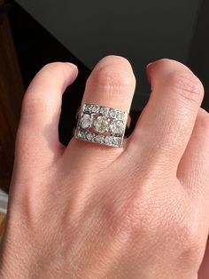 a woman's hand with a diamond ring on it