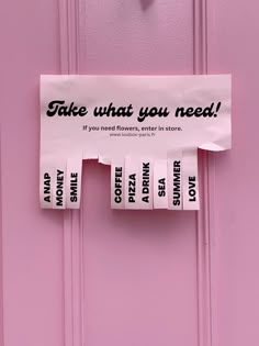 a pink door with a sign on it that says take what you need if you need flowers