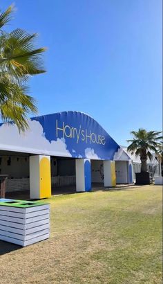 the entrance to harry's house with palm trees in the foreground and blue sky above