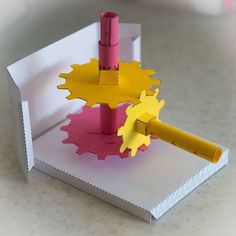 a piece of paper that has been cut out to look like a gear wheel and a pencil