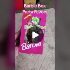 someone holding up a barbie party favors box