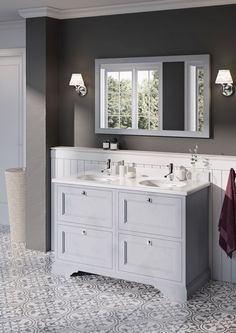 a bathroom with double sinks and two mirrors