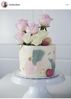 a white cake with pink flowers on top