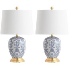 two blue and white vases with lamps on them