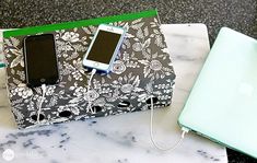 two cell phones are plugged into the charger on top of a marble table